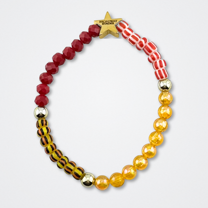 Broadway Stacks SAFARI collection.Yellow, red, animal print and gold colored beads on bracelet on gray background. Star logo bead to remind you that YOU SHINE! The Lion King and theatre fans.