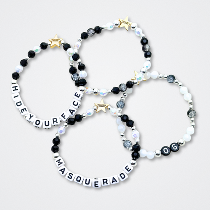Broadway Stacks MASQUERADE Collection. 4 stretch bracelets included in Stack. Black, white and silver colored beads. Letter beads that spell quotes. Gold star logo bead to remind you that you shine. Phantom of the Opera and Masquerade NYC fans.