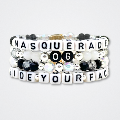 Broadway Stacks MASQUERADE Collection. 4 stretch bracelets included in Stack. Black, white and silver colored beads. Letter beads that spell quotes. Gold star logo bead to remind you that you shine. Phantom of the Opera and Masquerade NYC fans.