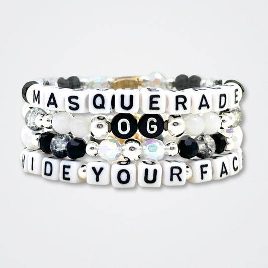 Broadway Stacks MASQUERADE Collection. 4 stretch bracelets included in Stack. Black, white and silver colored beads. Letter beads that spell quotes. Gold star logo bead to remind you that you shine. Phantom of the Opera and Masquerade NYC fans.
