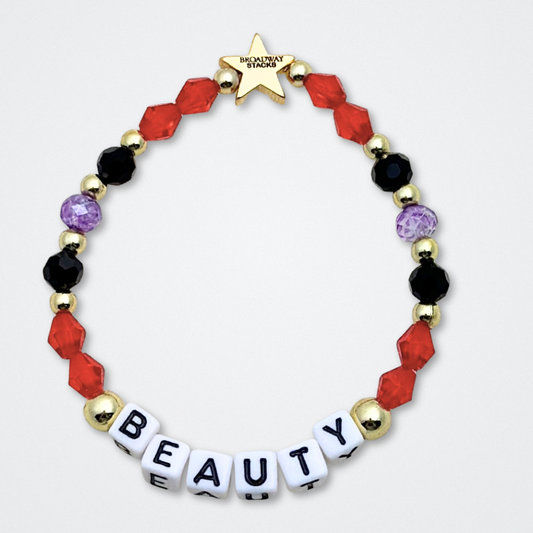 Broadway Stacks RED LIGHT Collection. 5 stretch bracelets included in Stack. Red, purple, black and gold colored beads. Letter beads that spell quotes. Gold star logo bead to remind you that You Shine. Moulin Rouge fans. 