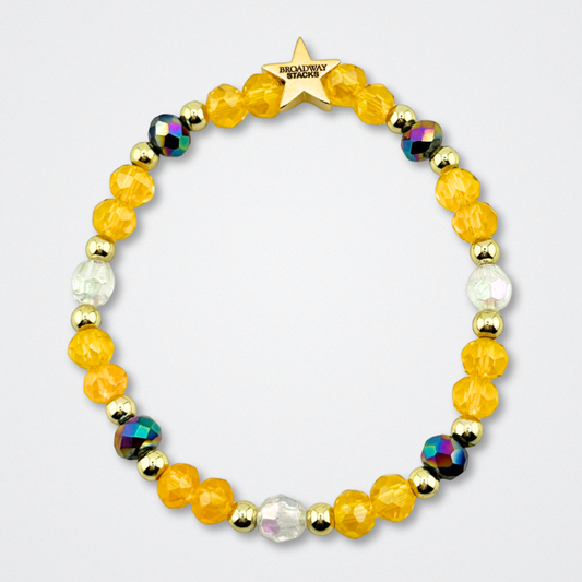 Broadway Stacks CONFIDENTIAL Collection. Color-coordinating bracelet with yellow, clear, black and gold colored beads. Star logo bead to remind you that you shine. Operation Mincemeat fans.