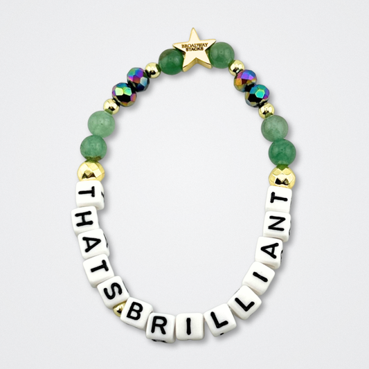 Broadway Stacks CONFIDENTIAL Collection. That's Brilliant bracelet with green, black and gold colored beads. Letter beads that spell quote. Star logo bead to remind you that you shine. Operation Mincemeat fans.