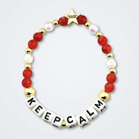 Broadway Stacks CONFIDENTIAL Collection. Keep Calm bracelet with red, clear and gold colored beads. Letter beads that spell quote. Star logo bead to remind you that you shine. Operation Mincemeat fans.