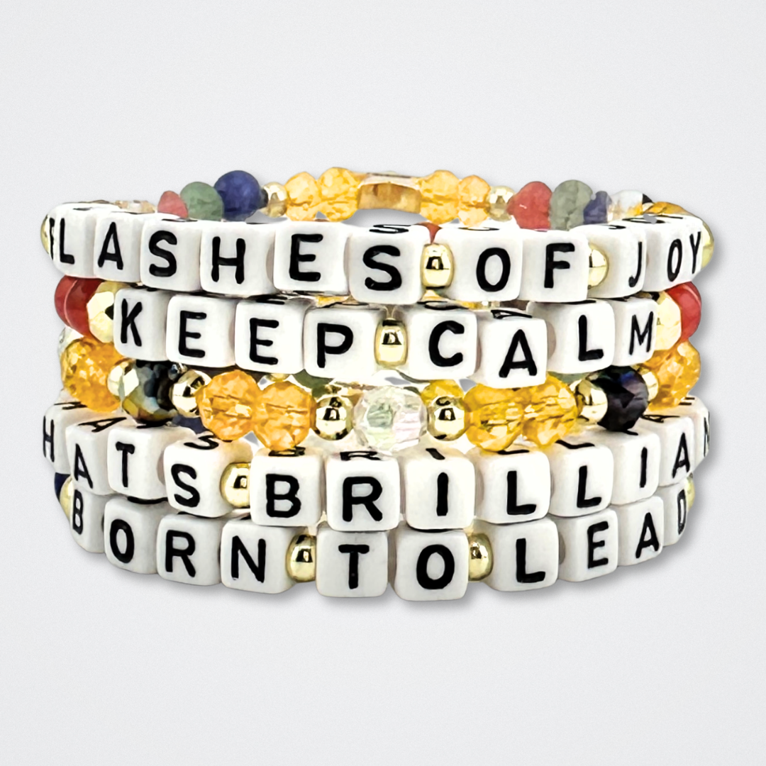 Broadway Stacks CONFIDENTIAL Collection. 5 stretch bracelets included in Stack. Black, white, red, blue, green, yellow and gold colored beads. Letter beads that spell quotes. Star logo bead to remind you that you shine. Operation Mincemeat fans.