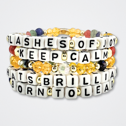 Broadway Stacks CONFIDENTIAL Collection. 5 stretch bracelets included in Stack. Black, white, red, blue, green, yellow and gold colored beads. Letter beads that spell quotes. Star logo bead to remind you that you shine. Operation Mincemeat fans.