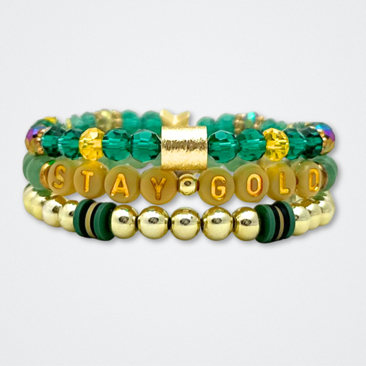 Broadway Stacks STAY GOLD collection. Stretch bracelets included in Stack. Gold, yellow, green and grey colored beads. Letter beads that have show quote or name. Broadway Stacks gold star logo bead to remind you that You Shine. The Outsiders the Musical fans.