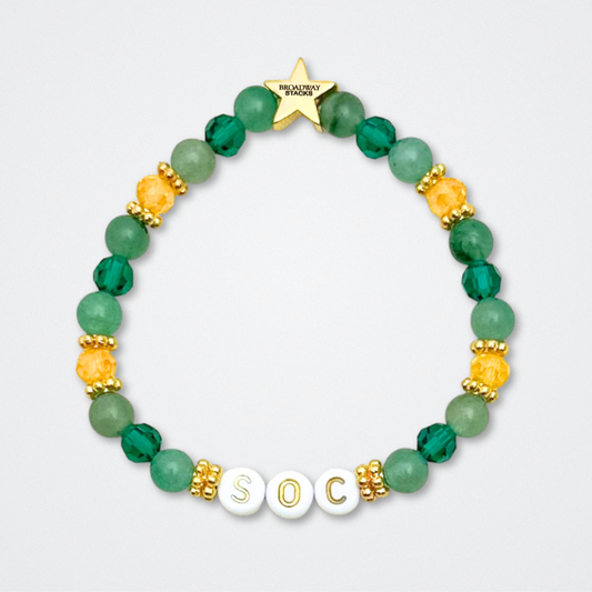 Broadway Stacks STAY GOLD collection. Stretch bracelets included in Stack. Gold, yellow, green and grey colored beads. Letter beads that have show quote or name. Broadway Stacks gold star logo bead to remind you that You Shine. The Outsiders the Musical fans.