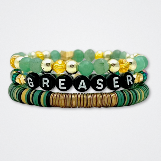 Broadway Stacks STAY GOLD collection. Stretch bracelets included in Stack. Gold, yellow, green and grey colored beads. Letter beads that have show quote or name. Broadway Stacks gold star logo bead to remind you that You Shine. The Outsiders the Musical fans.