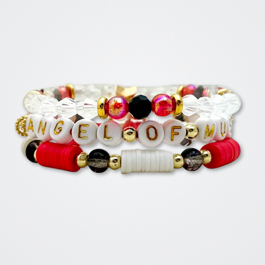 Broadway Stacks MASK collection. Bead bracelets included in Stack. Red, black, white and gold colored beads. Letter beads that spell quotes. Team Phantom, Team Christine, Team Raoul. Gold star logo bead to remind you that You Shine. Phantom of the Opera and Masquerade fans.