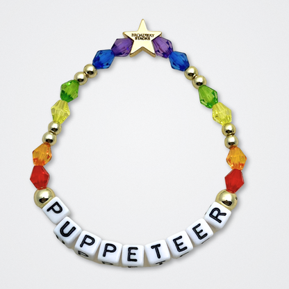 Broadway Stacks PUPPETRY Collection Special Edition bracelet. Stack of 3 bracelets. Rainbow and gold beads. Letter beads that spell Puppeteer and Puppet Joy. Gold star logo bead to remind you that You Shine. 