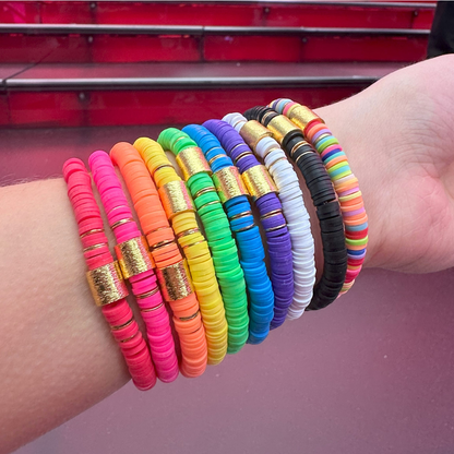 Broadway Stacks rainbow colors elastic stretch bracelets with gold color accents. Star logo bead to remind you that You Shine. Available in red pink orange yellow green blue purple white black and mulit-color. TKTS Steps.