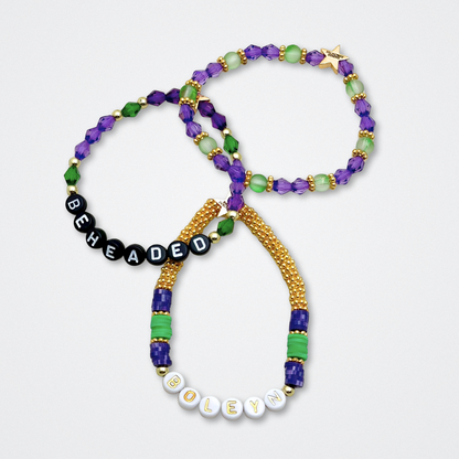 Broadway Stacks QUEEN collection. Stretch bracelets included in Stack. Gold, yellow, green, white, red, pink and blue colored beads. Letter beads that spell each queen. Also Herstory collection. Broadway Stacks gold star logo bead to remind you that You Shine. SIX the Musical fans.