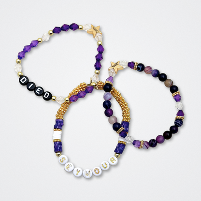 Broadway Stacks QUEEN collection. Stretch bracelets included in Stack. Gold, yellow, green, white, red, pink and blue colored beads. Letter beads that spell each queen. Also Herstory collection. Broadway Stacks gold star logo bead to remind you that You Shine. SIX the Musical fans.