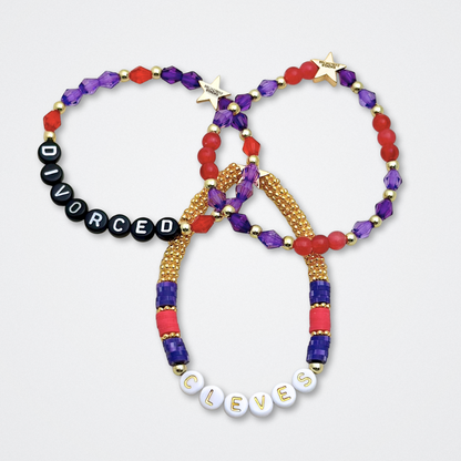 Broadway Stacks QUEEN collection. Stretch bracelets included in Stack. Gold, yellow, green, white, red, pink and blue colored beads. Letter beads that spell each queen. Also Herstory collection. Broadway Stacks gold star logo bead to remind you that You Shine. SIX the Musical fans.