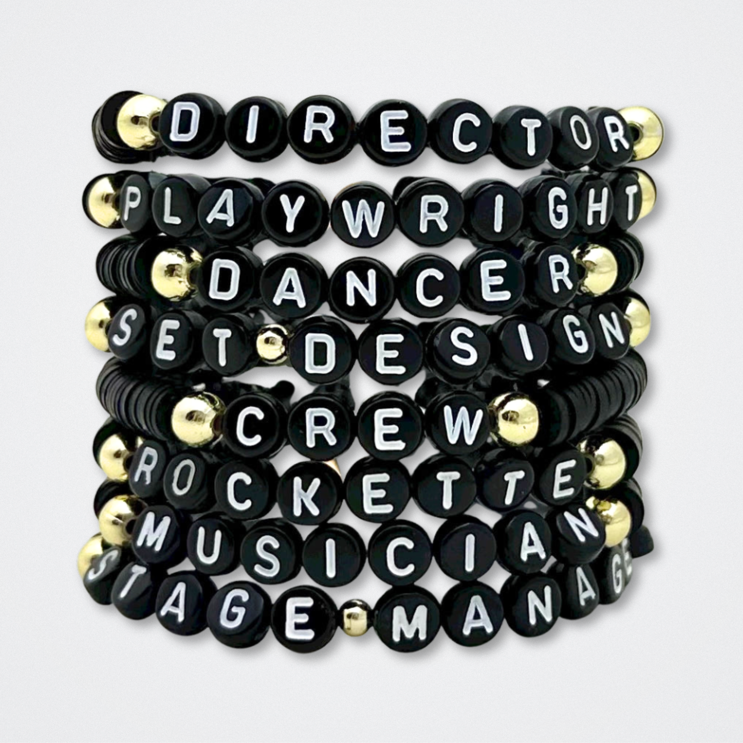 Set of black bracelets with white lettering on a white background. Broadway Stacks theatre-themed Spotlight bracelets highlighting ALL theater roles. Because everyone deserves to shine.