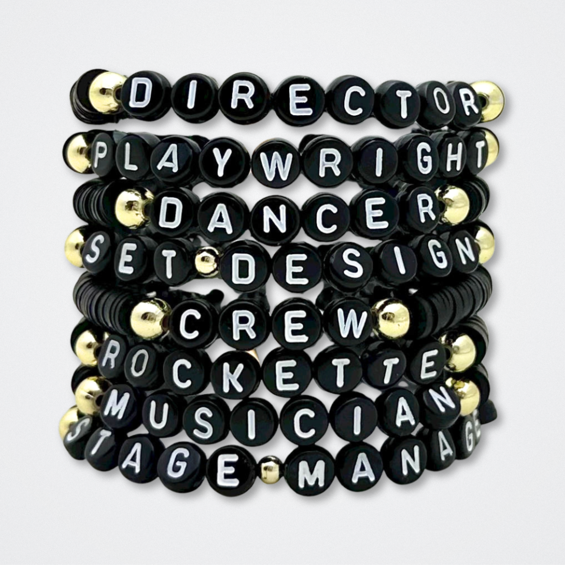 Set of black bracelets with white lettering on a white background. Broadway Stacks theatre-themed Spotlight bracelets highlighting ALL theater roles. Because everyone deserves to shine.