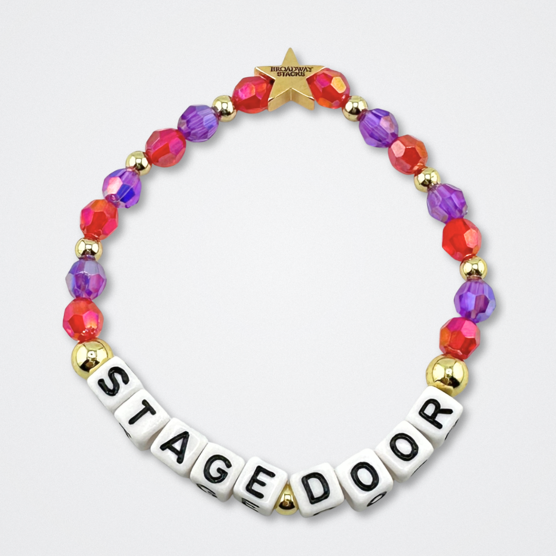Broadway Stacks STAGE DOOR bead bracelet displayed on a gray background. Red and purple beads. Letter beads spell out quote. Signature star bead to remind you: YOU SHINE! 