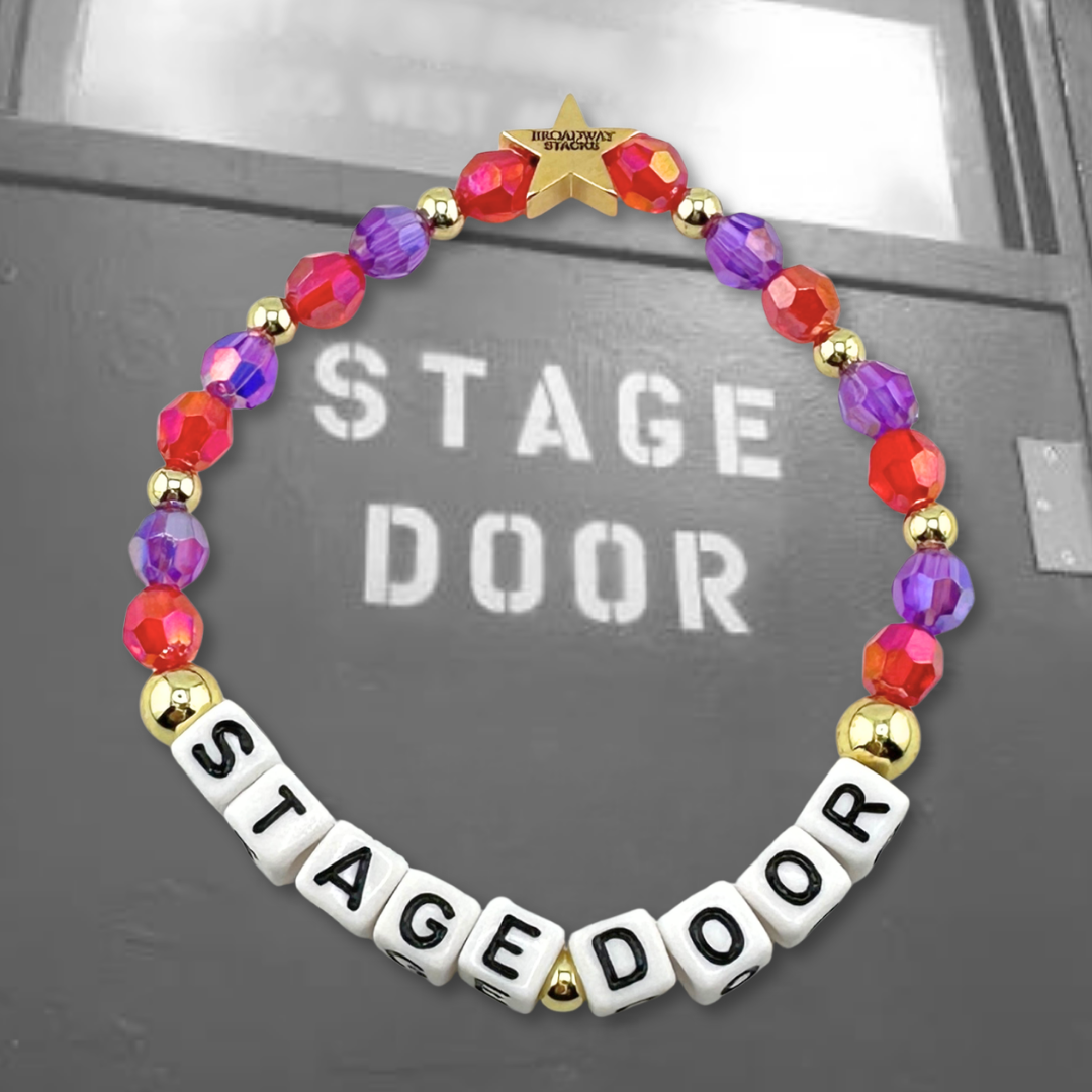 Broadway Stacks STAGE DOOR bead bracelet displayed on a black/white photo of a stage door. Red and purple beads. Letter beads spell out quote. Signature star bead to remind you: YOU SHINE! 