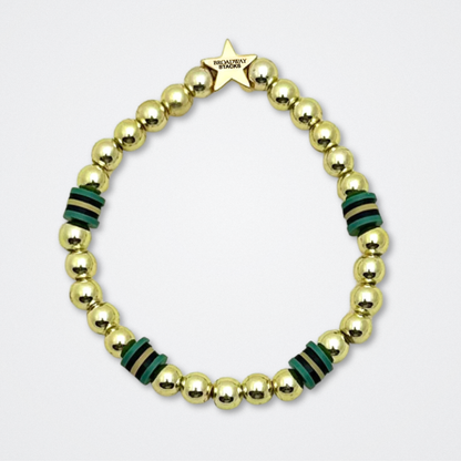 Broadway Stacks STAY GOLD bracelet inspired by The Outsiders Musical. Dark green and gold beads. Logo star bead to remind you that YOU SHINE. Displayed on a gray background.