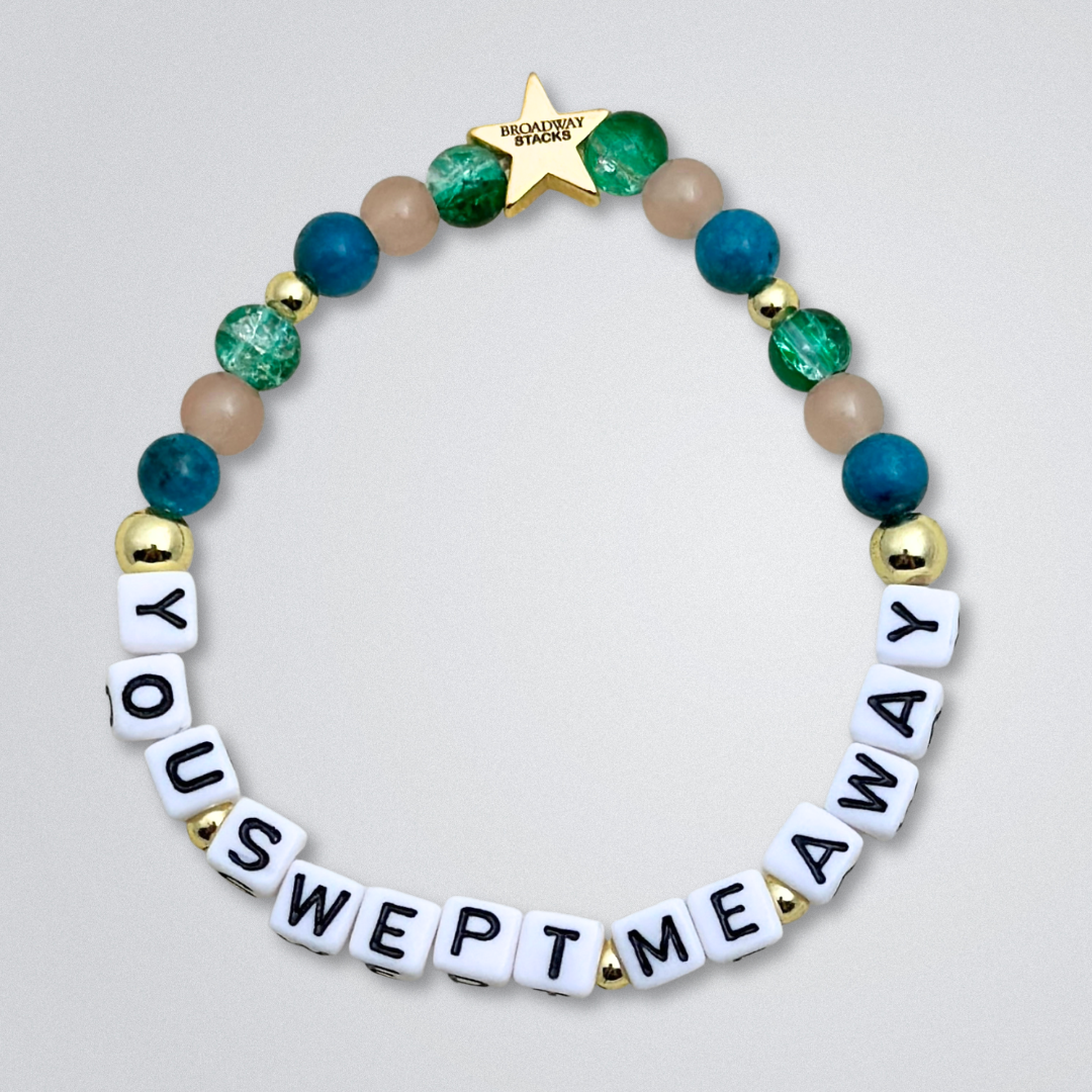 Broadway Stacks SAILOR Collection. 5 stretch bracelets included in Stack. Teal, green, blue and gold colored beads. Letter beads that spell quotes. Swept Away the Musical. Gold star logo bead to remind you that you shine.