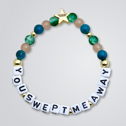 Broadway Stacks SAILOR Collection. 5 stretch bracelets included in Stack. Teal, green, blue and gold colored beads. Letter beads that spell quotes. Swept Away the Musical. Gold star logo bead to remind you that you shine.