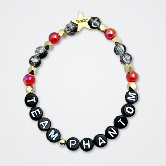 Broadway Stacks MASK collection. Bead bracelets included in Stack. Red, black, white and gold colored beads. Letter beads that spell quotes. Team Phantom, Team Christine, Team Raoul. Gold star logo bead to remind you that You Shine. Phantom of the Opera and Masquerade fans.