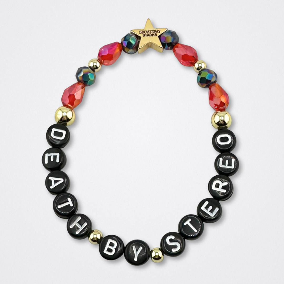 Bead bracelet with letter beads spelling 'DEATH BY STEREO' on a gray background. Broadway Stacks VAMPIRE Collection. Black, red and gold colored beads. Gold star logo bead to remind you that you shine. Inspired by The Lost Boys Musical.