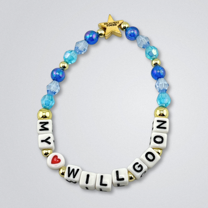 Bead bracelet with letter beads spelling 'MY <3 WILL GO ON' on a gray background. Broadway Stacks UNSINKABLE Collection. Blues and gold colored beads. Gold star logo bead to remind you that you shine. Inspired by Titanique the Musical.