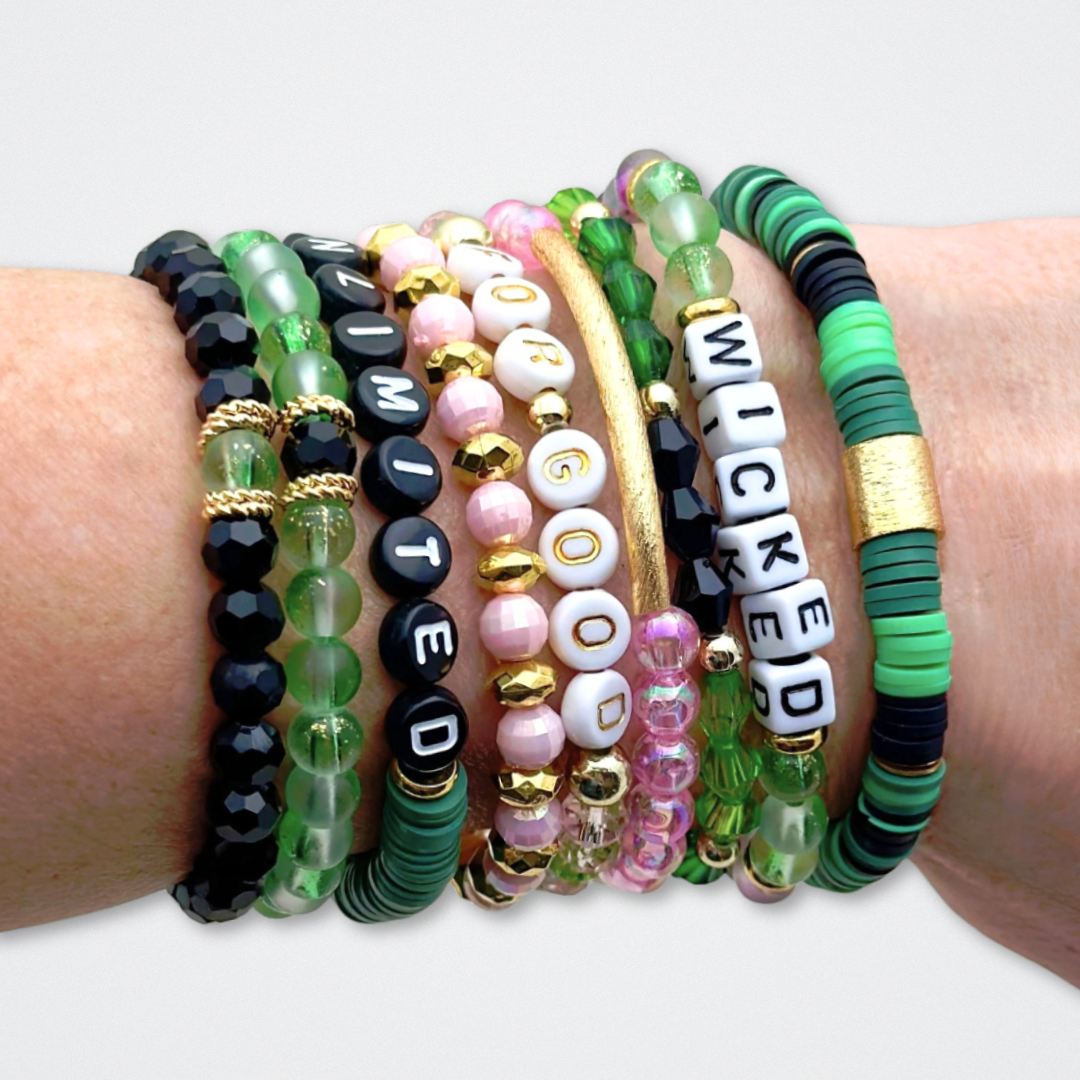 Broadway Stacks WITCH collection. 3 stretch bracelets included in Stack. Greens, pinks, black and gold colored beads. Letter beads that spell quotes. Gold star logo bead to remind you that You Shine. Wicked fans.