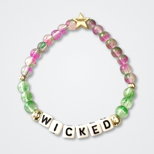 Beaded bracelet with 'WICKED' letters on a light gray background. Broadway Stacks WITCH collection. Greens, pinks and gold colored beads. Gold star logo bead to remind you that You Shine. 