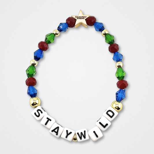 Broadway Stacks STAY WILD bead bracelet. Green, blue, dark red and gold color beads on a gray background.
