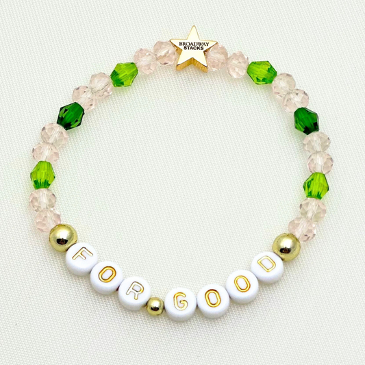 Broadway Stacks Witch collection. 3 stretch bracelets included in Stack. Greens, pinks, black and gold colored beads. Letter beads that spell Wicked. Gold star logo bead on every bracelet. 