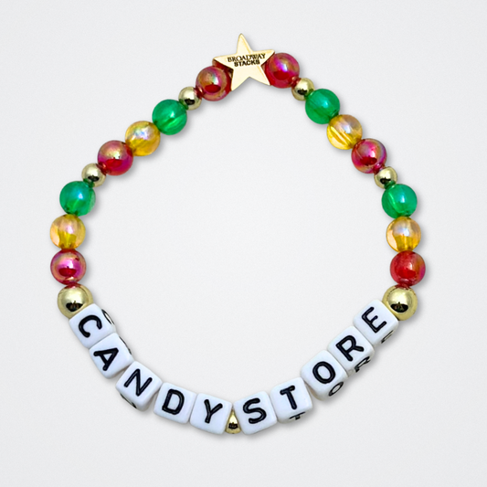 Broadway Stacks CORN NUTS Collection. 5 stretch bracelets included in Stack. Red, yellow, green, blue, black and gold colored beads. Letter beads that spell quotes. Gold star logo bead to remind you that you shine. Heathers the Musical fans.