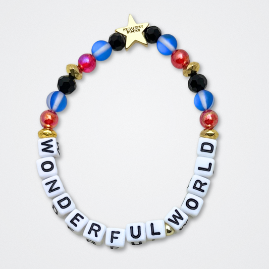 Broadway Stacks JAZZY Collection. 5 stretch bracelets included in Stack. Red, blue, black and gold colored beads. Letter beads that spell quotes. Gold star logo bead to remind you that you shine. Wonderful World musical and Louis Armstrong fans.